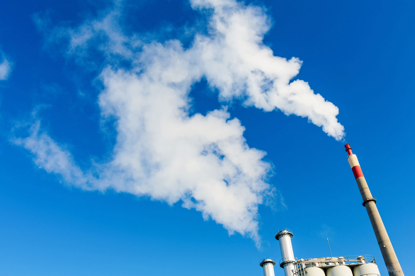Emissions Clouds of steam or smoke coming from industrial chimneys