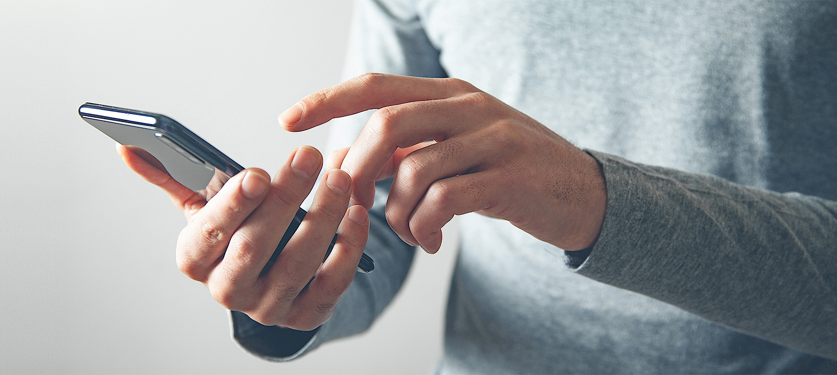 Contact us Man typing on smartphone